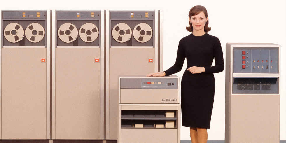 Burroughs B-280 Electronic Data Processing System: row of tape drives with operator console and spokesperson